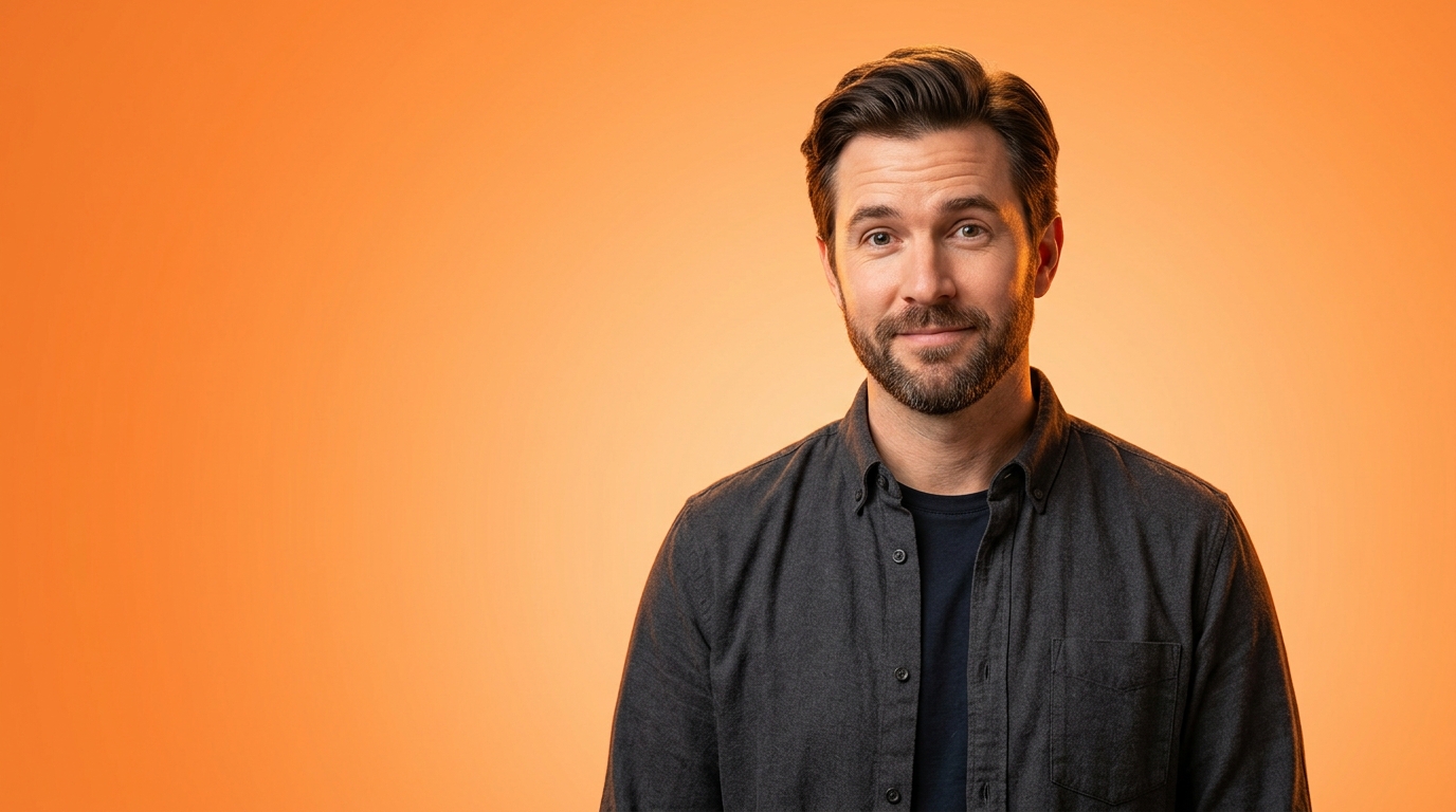A man photographed against a completely plain blown-out orange gradient with space around him for text